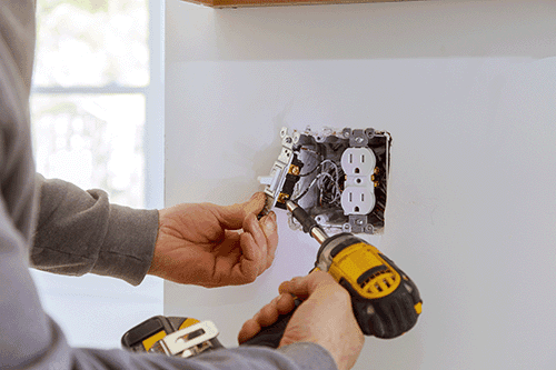 Electrician testing a panel to keep solar equipment protected
